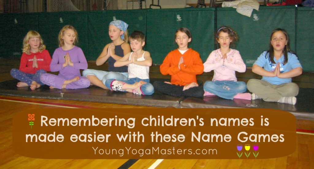 A row of children doing a yoga games to help remember each others names
