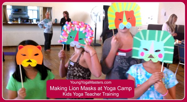 4 kids hold up their Lion Masks at Kids Yoga Teacher Training Yoga Camp