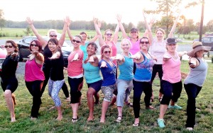 Kids Yoga Teachers in warrior pose outside at the Kids yoga teacher summer certification intensive rcys