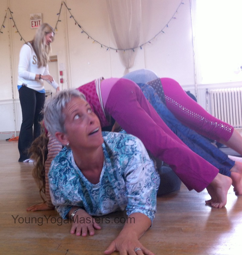 downward dog tunnel in kids yoga with yoga teacher trainers during certification